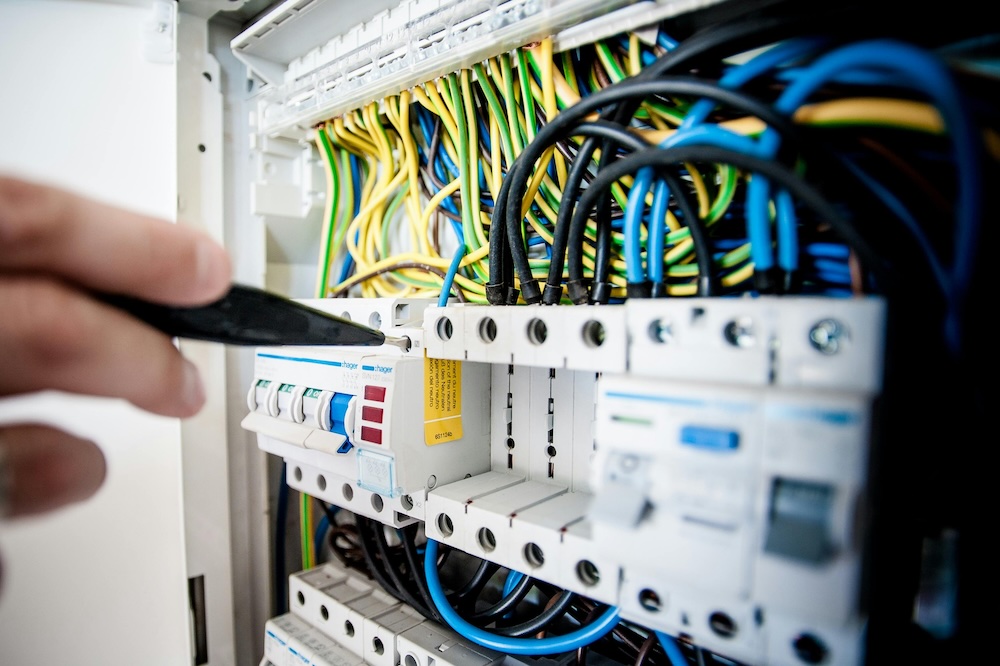 Professional electrician installing wiring in a Singapore home, ensuring safe and efficient electrical systems